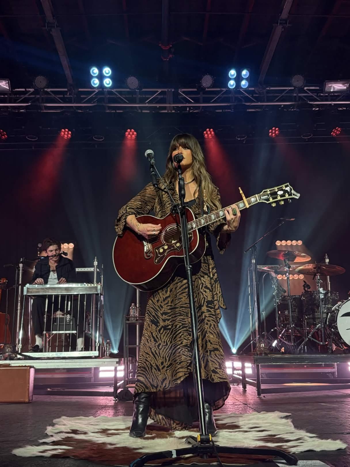 Ella Langley performing with a guitar on stage in Grand Rapids, Michigan