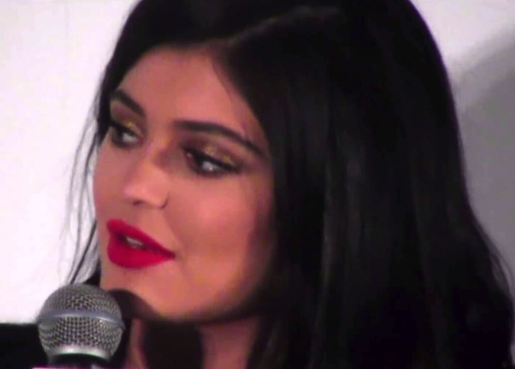 Kylie Jenner speaking into a microphone during a 2015 interview
