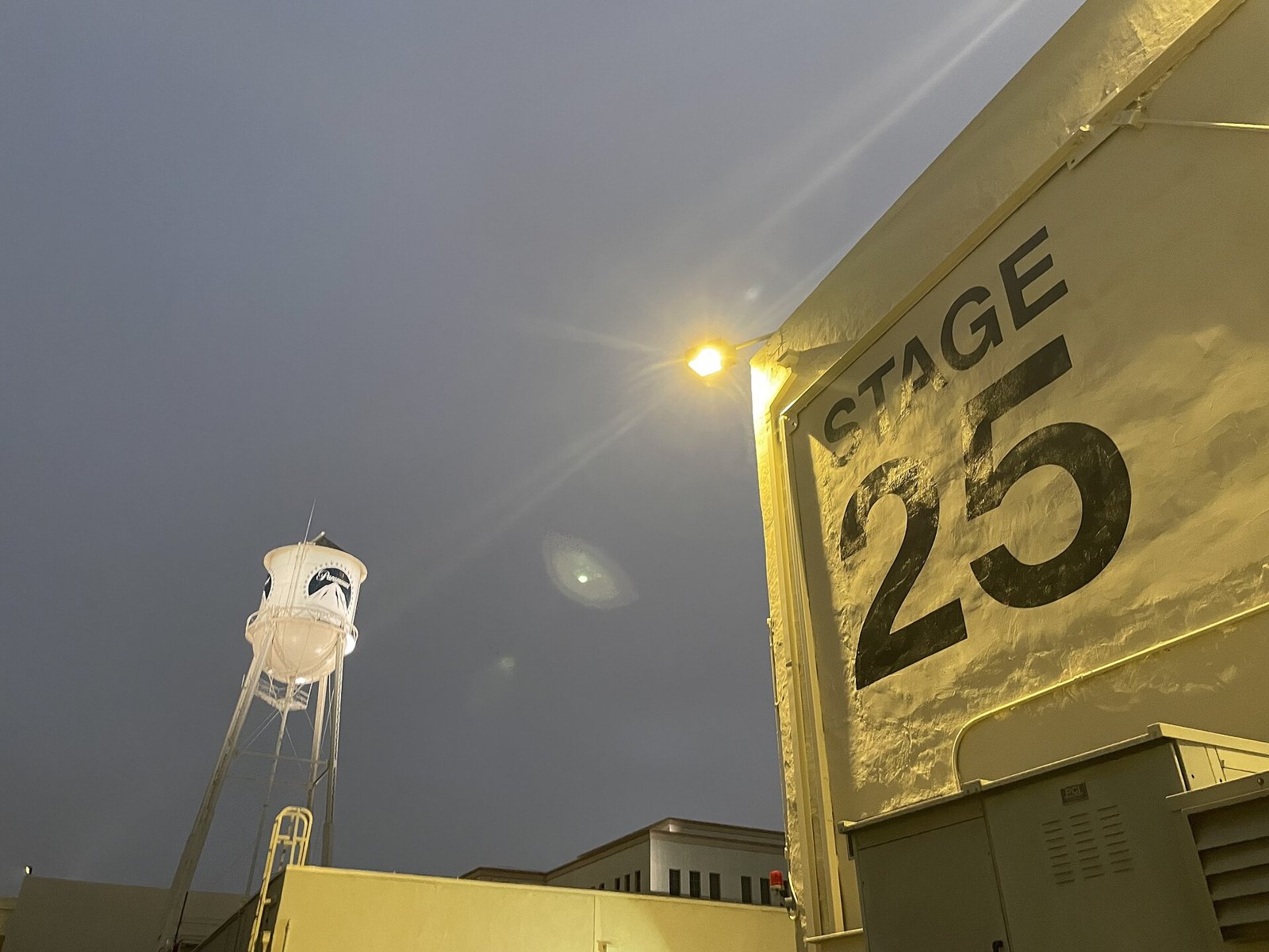 The Paramount water tower and Stage 25 lit up at night