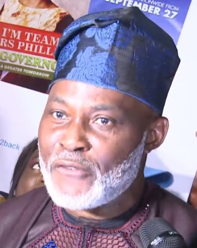 Richard Mofe-Damijo in a blue cap at a film premiere