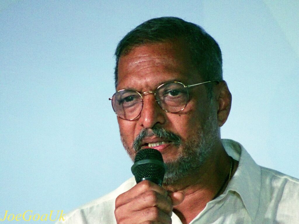 Nana Patekar in glasses speaking into a microphone at a film festival in Goa