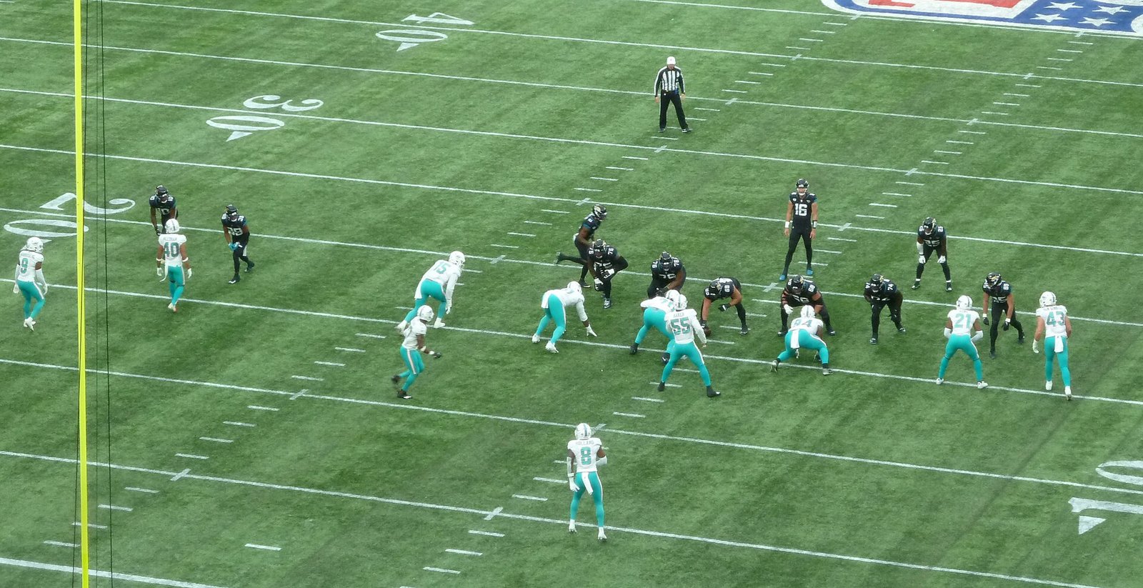 An NFL game in progress at Tottenham Hotspur Stadium with the Jacksonville Jaguars on the field