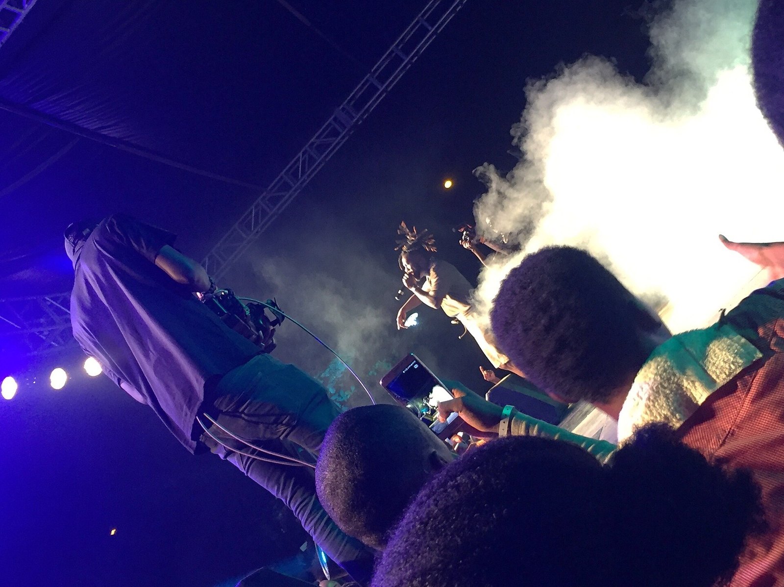 Burna Boy performing to a crowd at a concert in Lagos